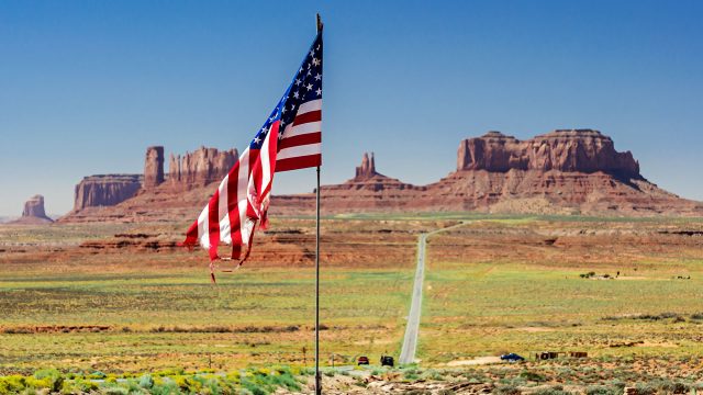 U.S. Flag in front of Monument Valley in Utah, USA
