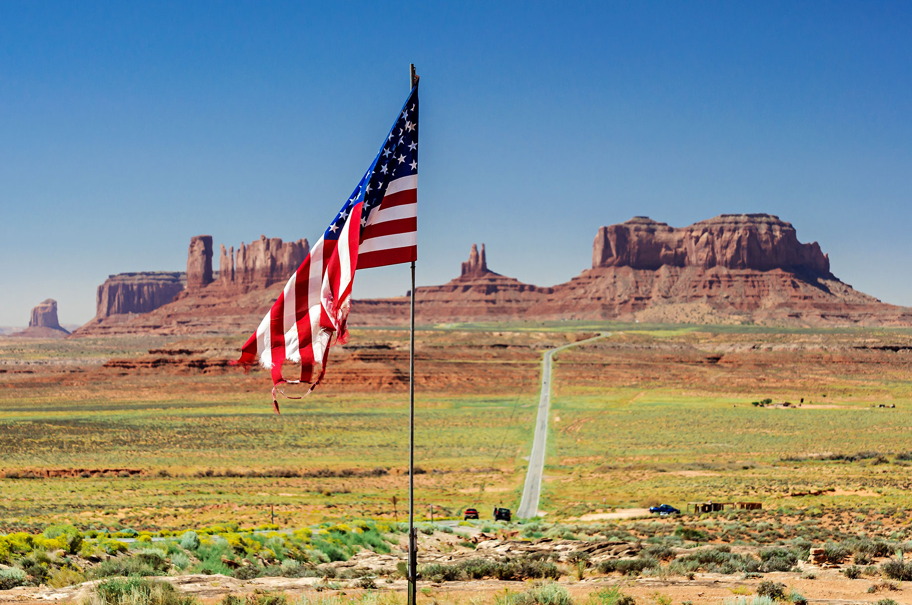 U.S. Flag in front of Monument Valley in Utah, USA