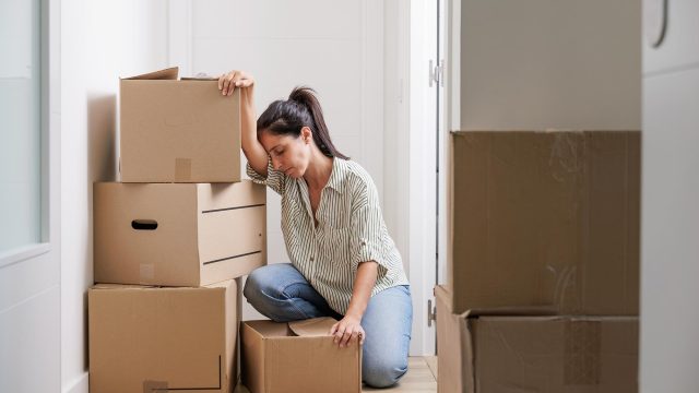 Woman Stressed with Boxes in New Home