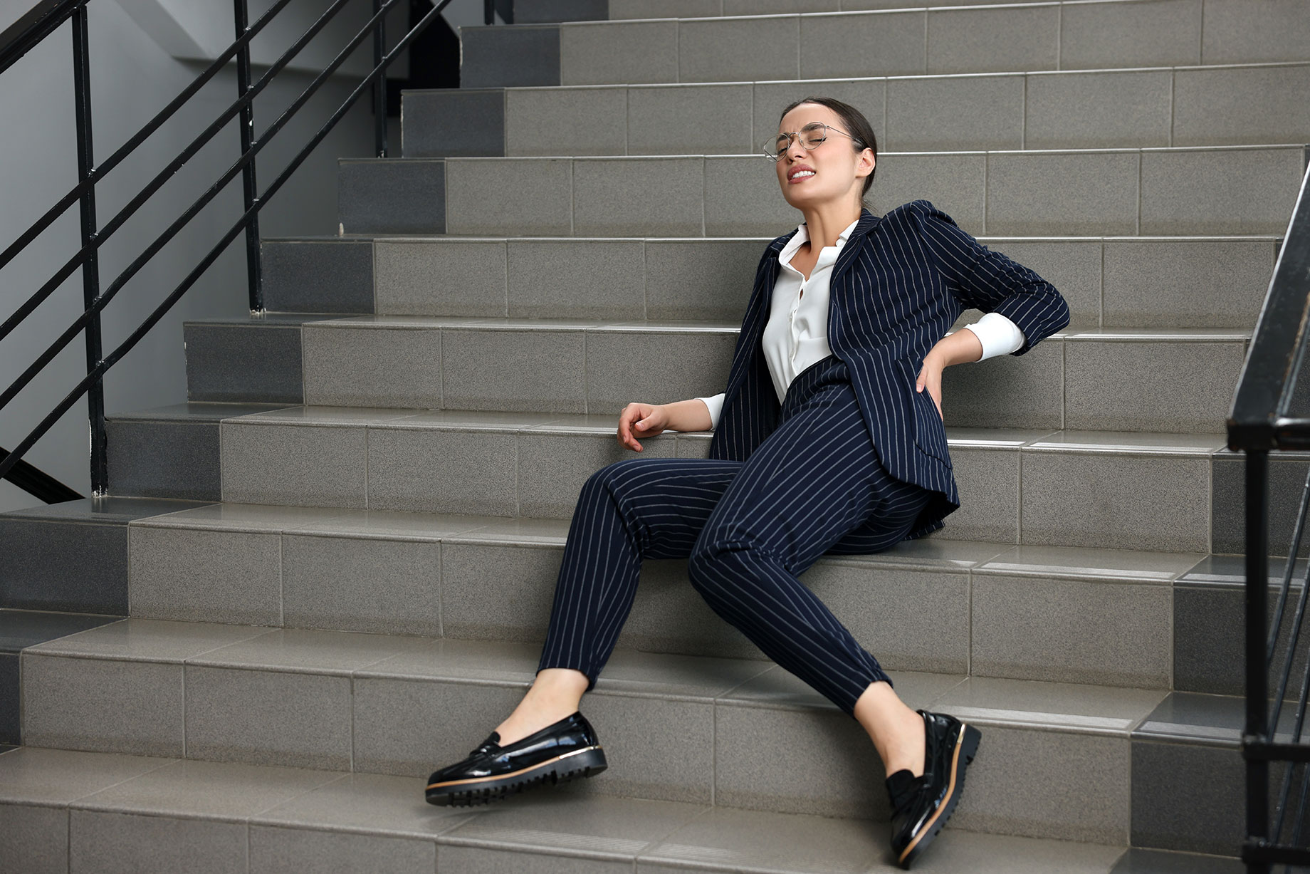 Businesswoman Falling Down Stairs