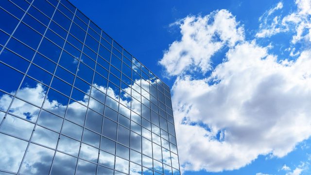 Commercial Building Reflecting the Sky and Clouds