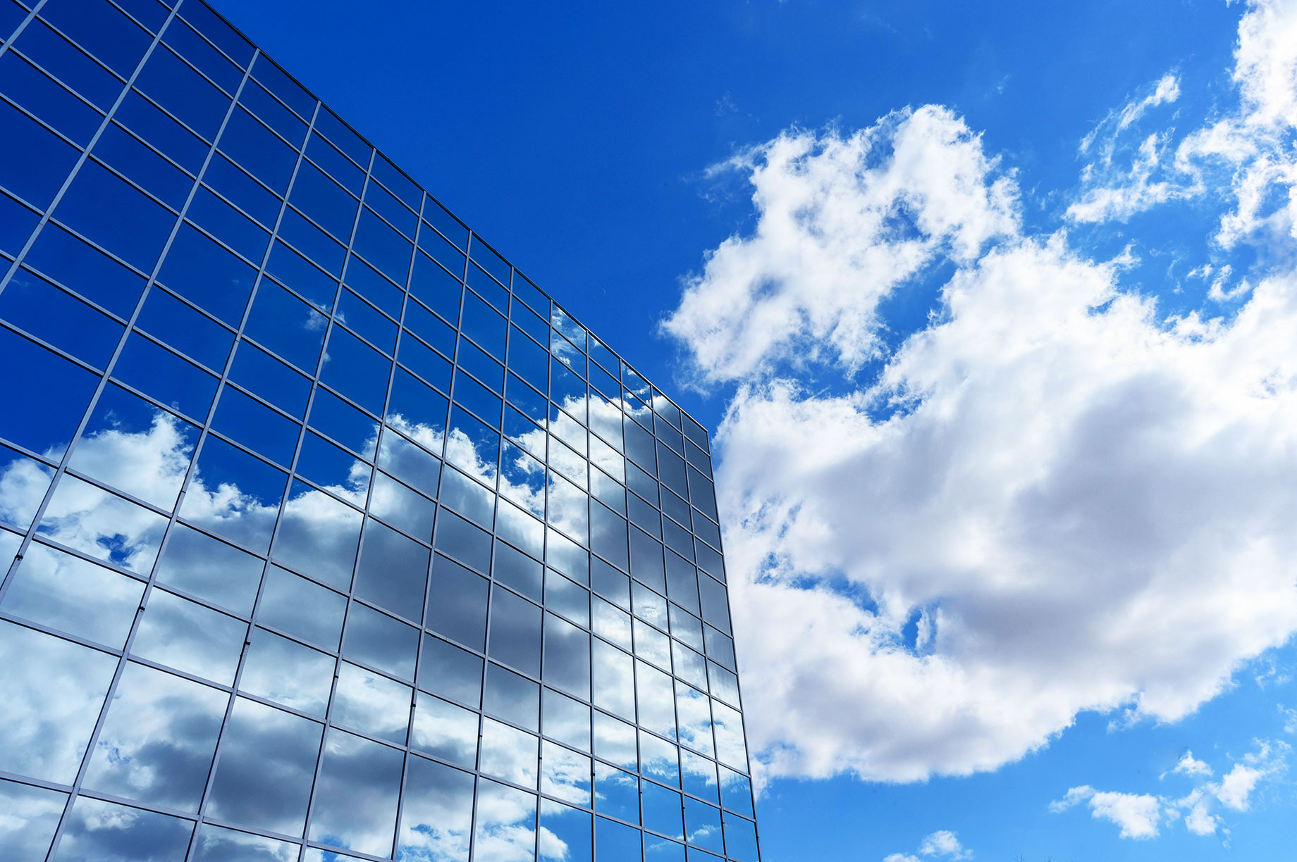 Commercial Building Reflecting the Sky and Clouds