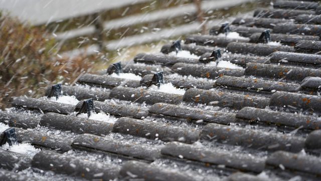 Hailstorm on the Tiled Roof of a House