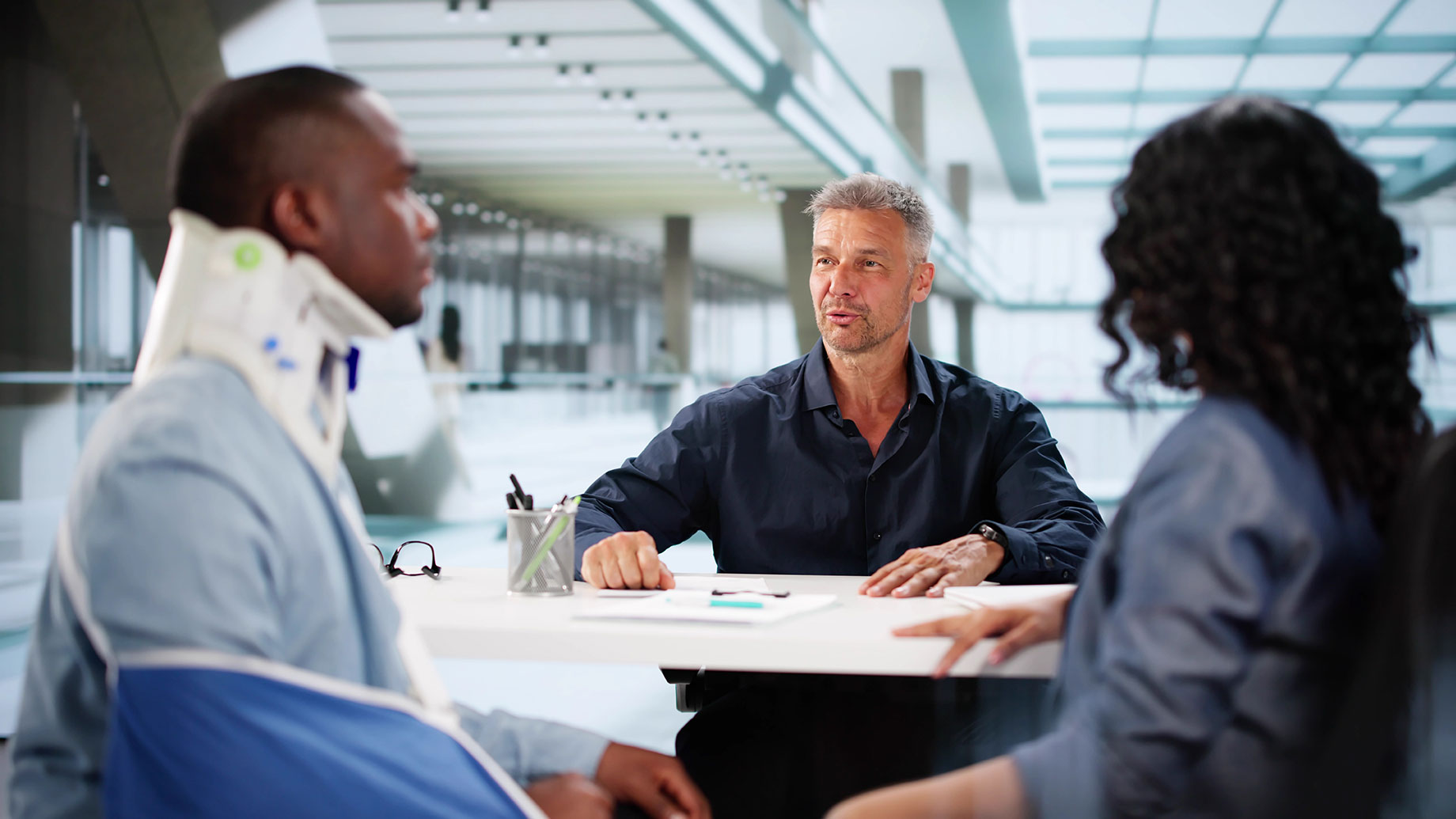 Personal Injury Attorney Advising Injured Client with a Neck Brace