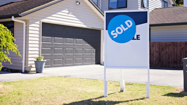 Real Estate For Sale Sign on Lawn with Sold Sticker