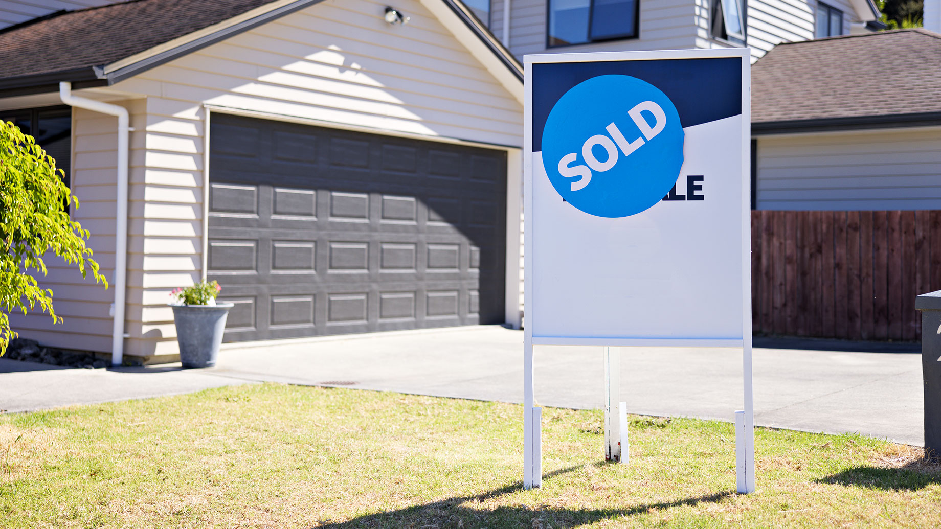 Real Estate For Sale Sign on Lawn with Sold Sticker