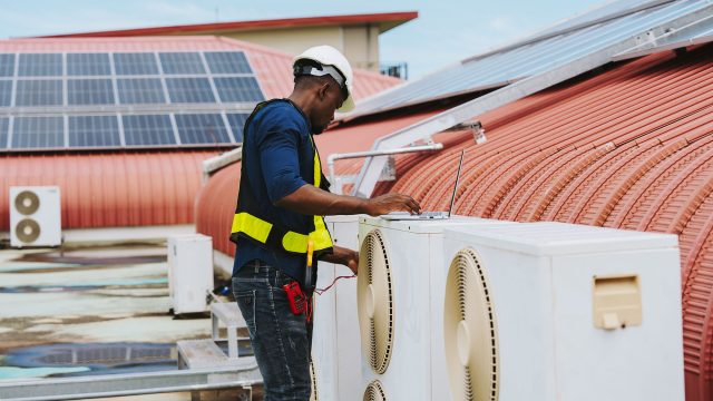 Serviceman Working on an Air Conditioning System