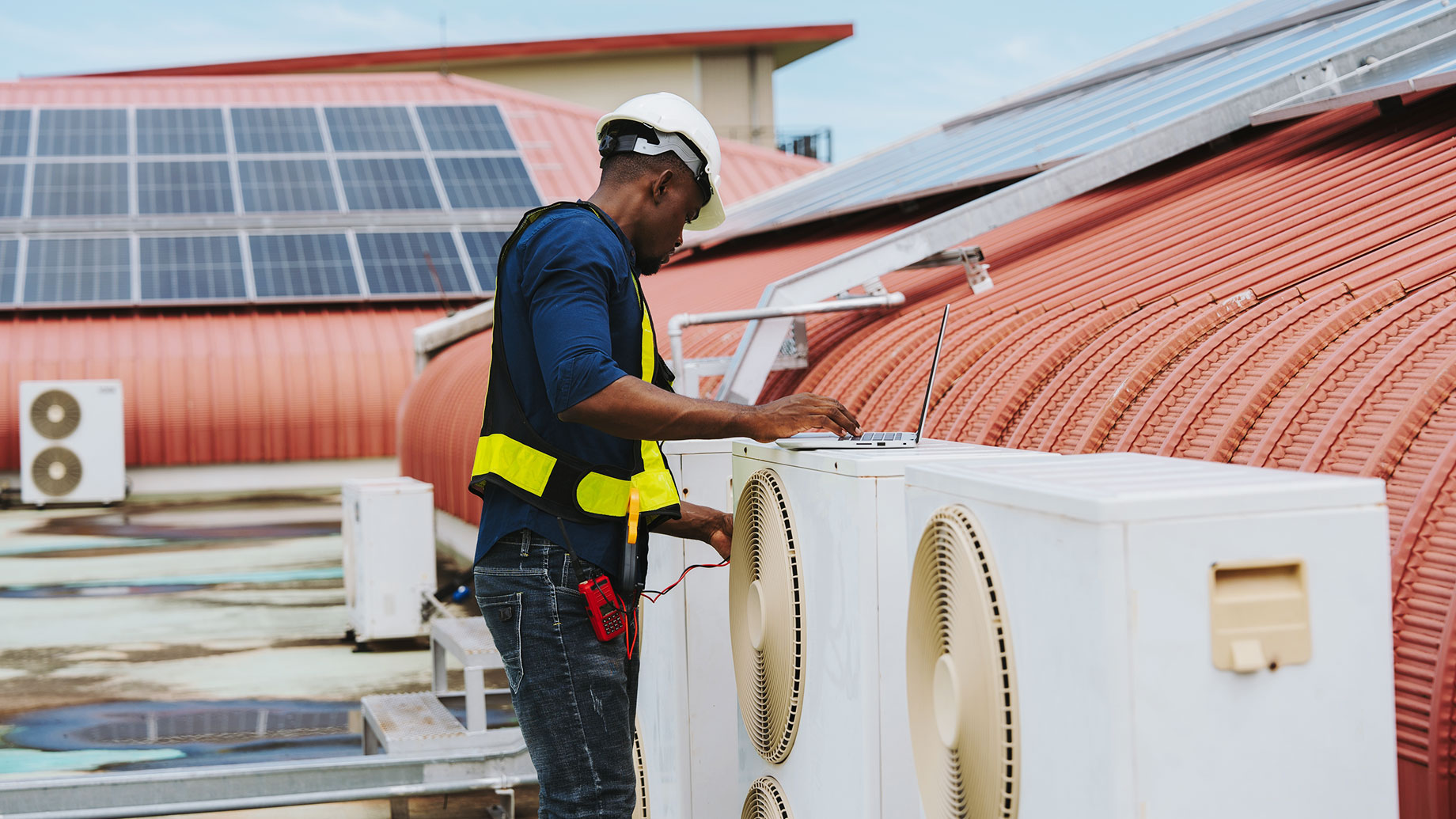 Serviceman Working on an Air Conditioning System