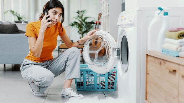 Woman on the Phone with a Technician to Troubleshoot Washing Machine