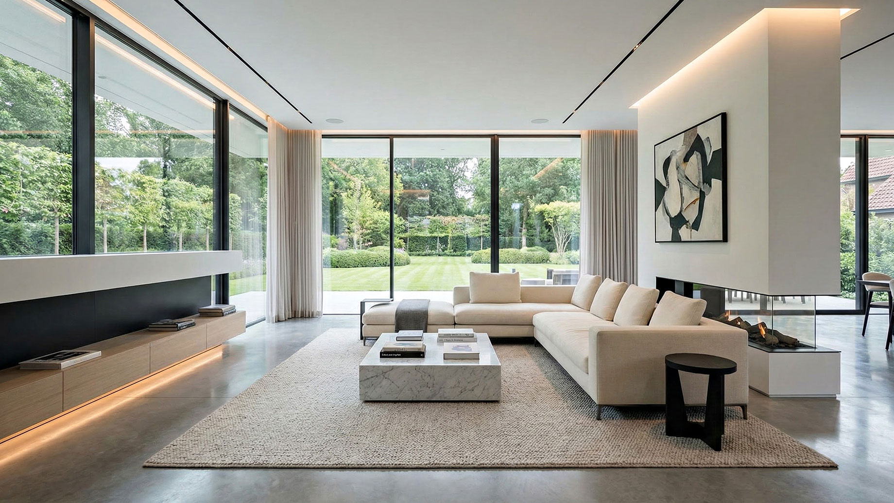 A spacious, high-end modern living room featuring a spotless white sectional sofa, polished flooring, and large floor-to-ceiling windows letting in natural light, illustrating the calming effect of a professionally cleaned home.