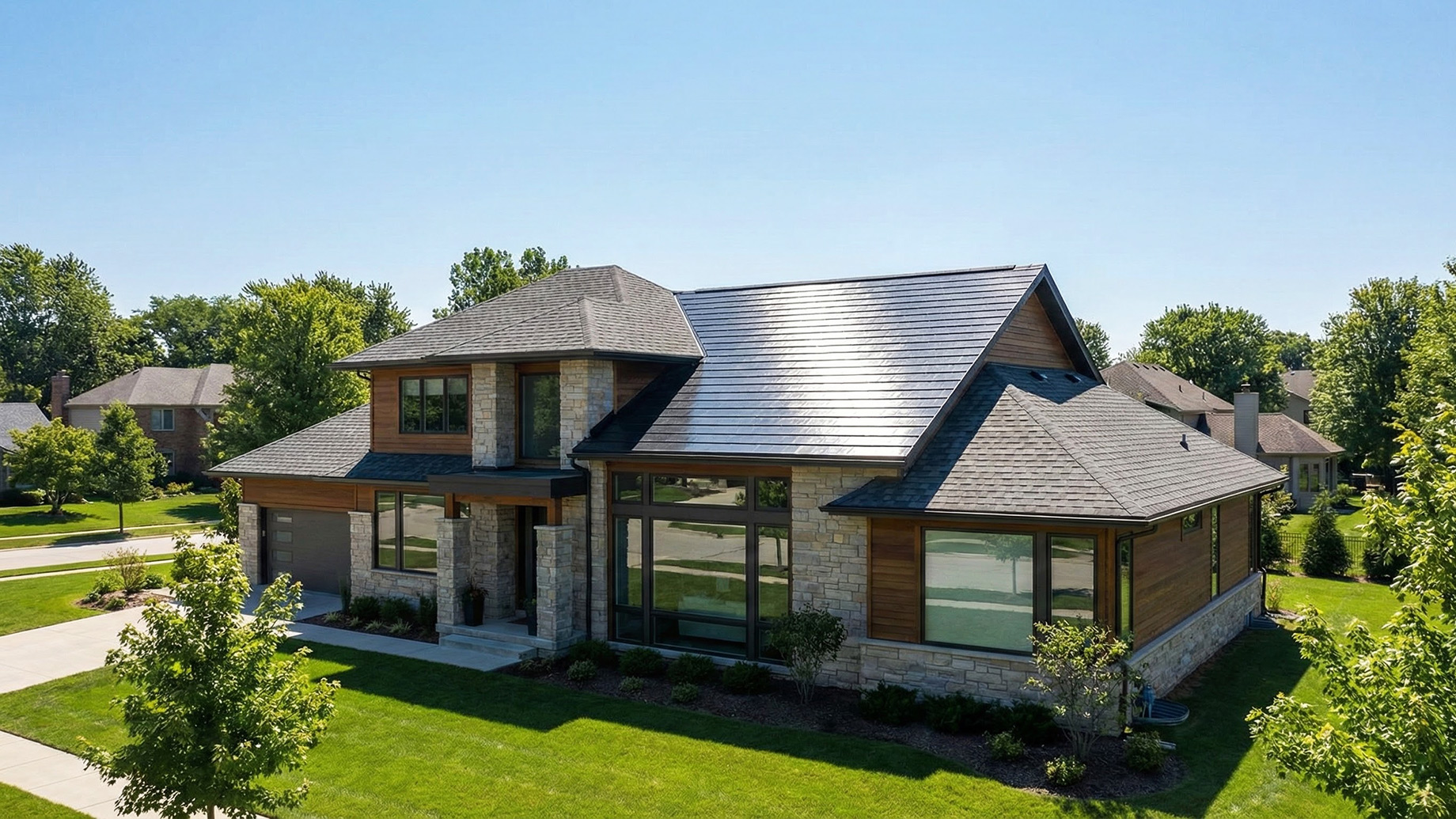 A contemporary residence featuring a seamless installation of solar shingles that blend with the roofline, demonstrating the aesthetic energy solutions provided by a trusted solar company and local roofing company.