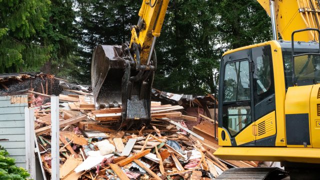 Professional House Demolition by an Excavator Machine