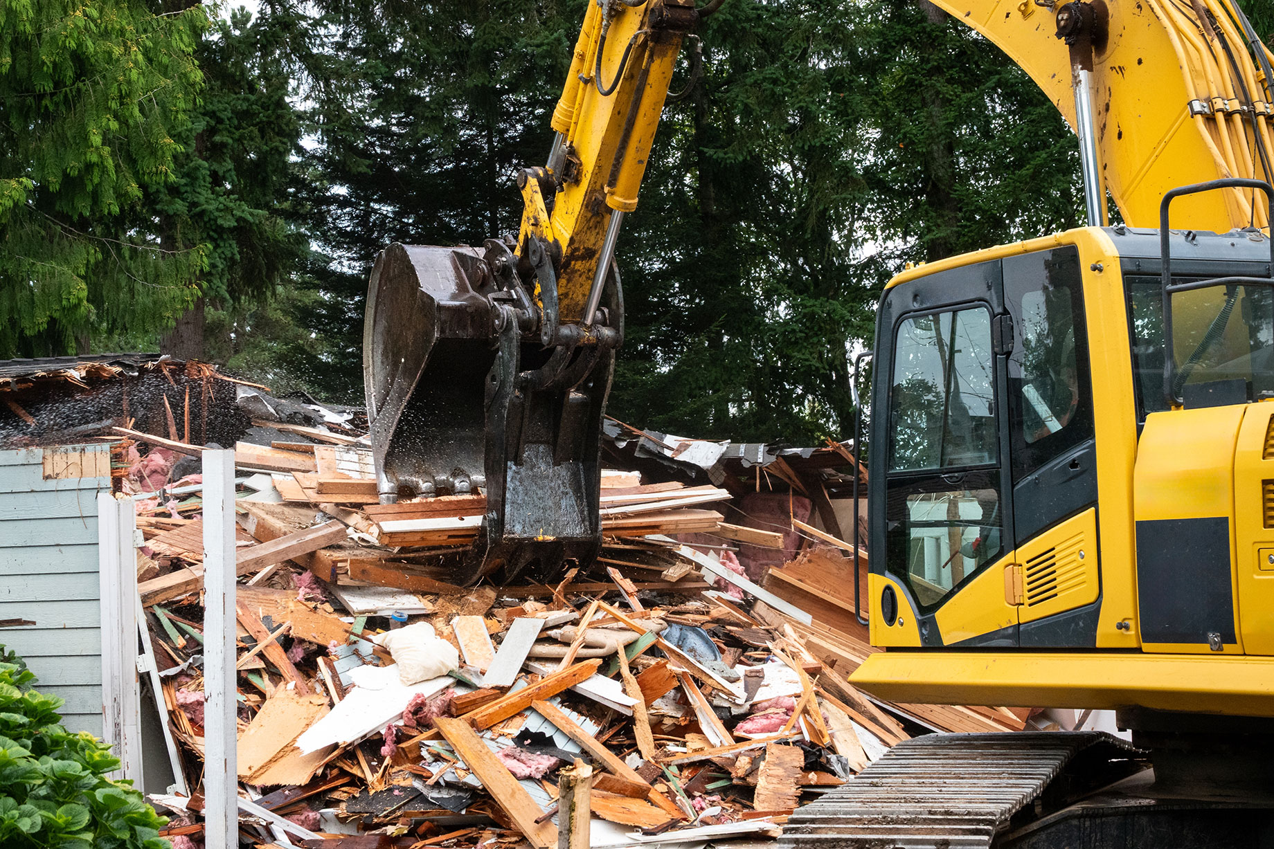 Professional House Demolition by an Excavator Machine