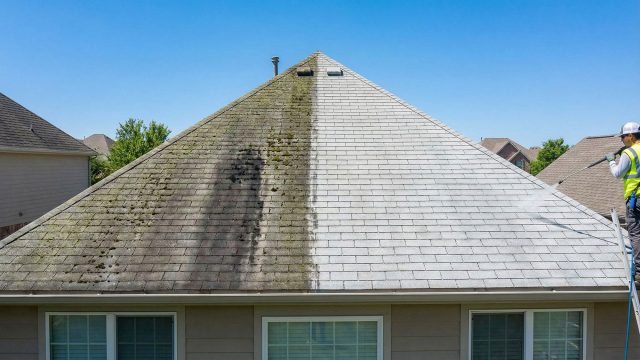 A side-by-side comparison on a residential home showing a dirty roof covered in dark streaks, algae, and moss on the left, contrasted with a professionally cleaned section on the right where the original shingle color is fully restored.