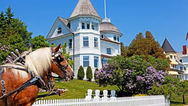 The Wedding Cake Cottage on the West Bluff on Michigan's Mackinac Island with a Horse and Carriage