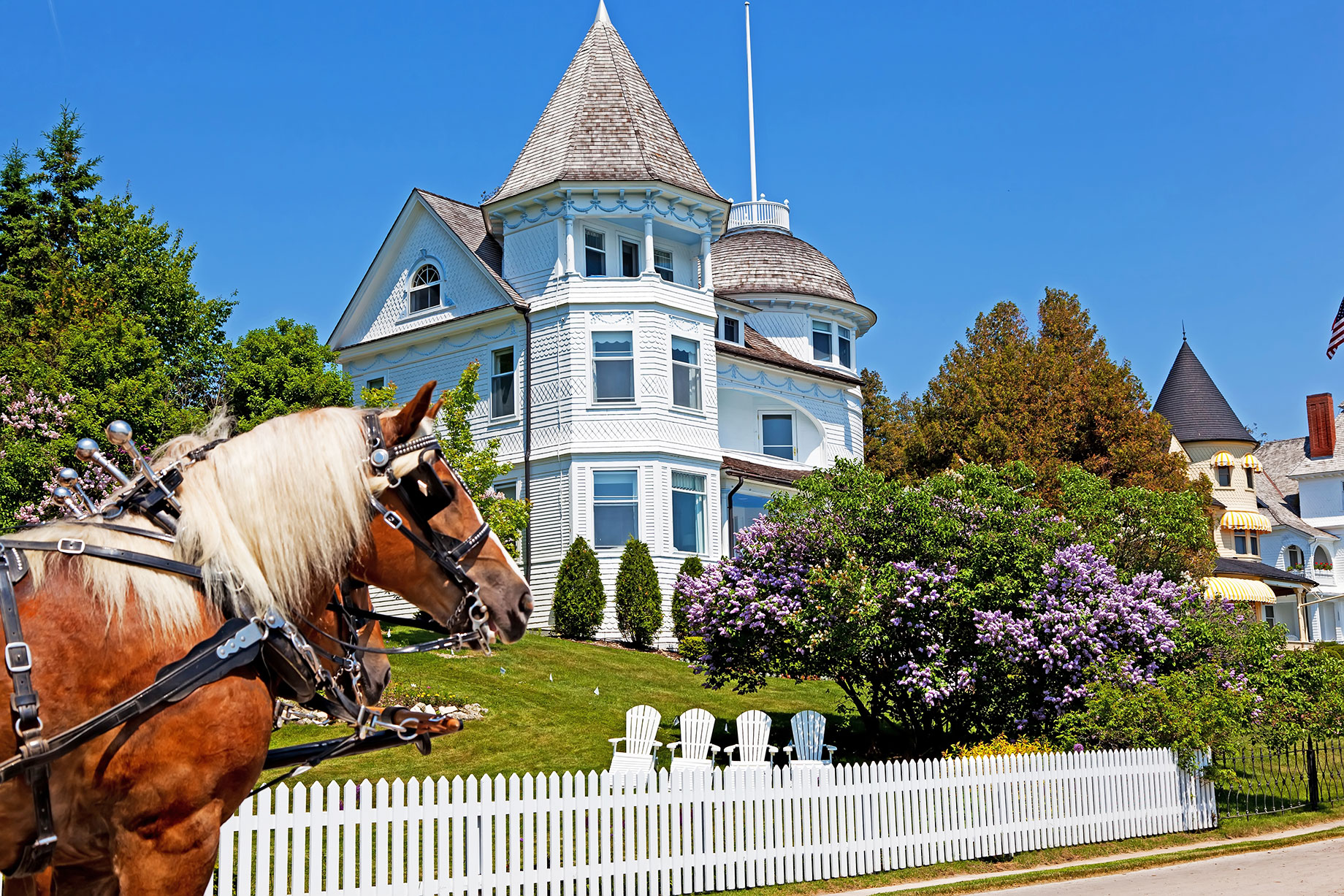 The Wedding Cake Cottage on the West Bluff on Michigan's Mackinac Island with a Horse and Carriage