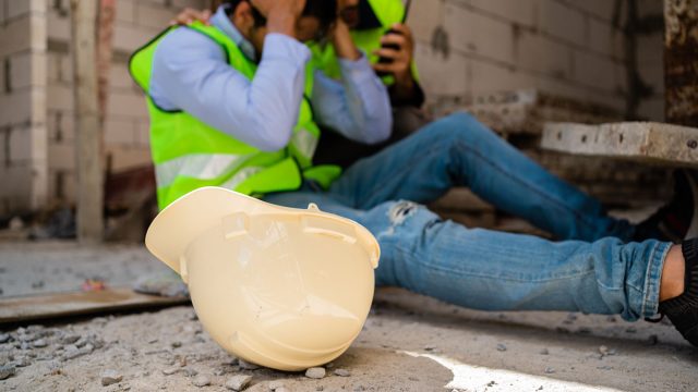 Worker Injured on the Ground with Hard Hat Fallen Off