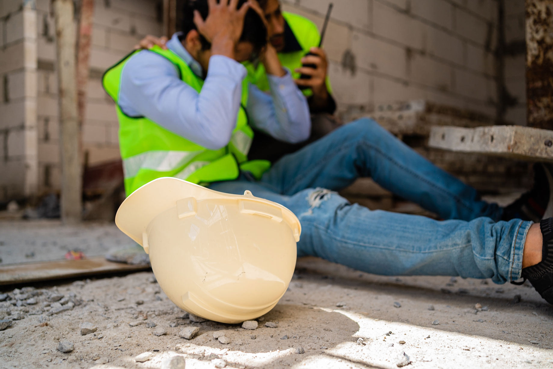 Worker Injured on the Ground with Hard Hat Fallen Off
