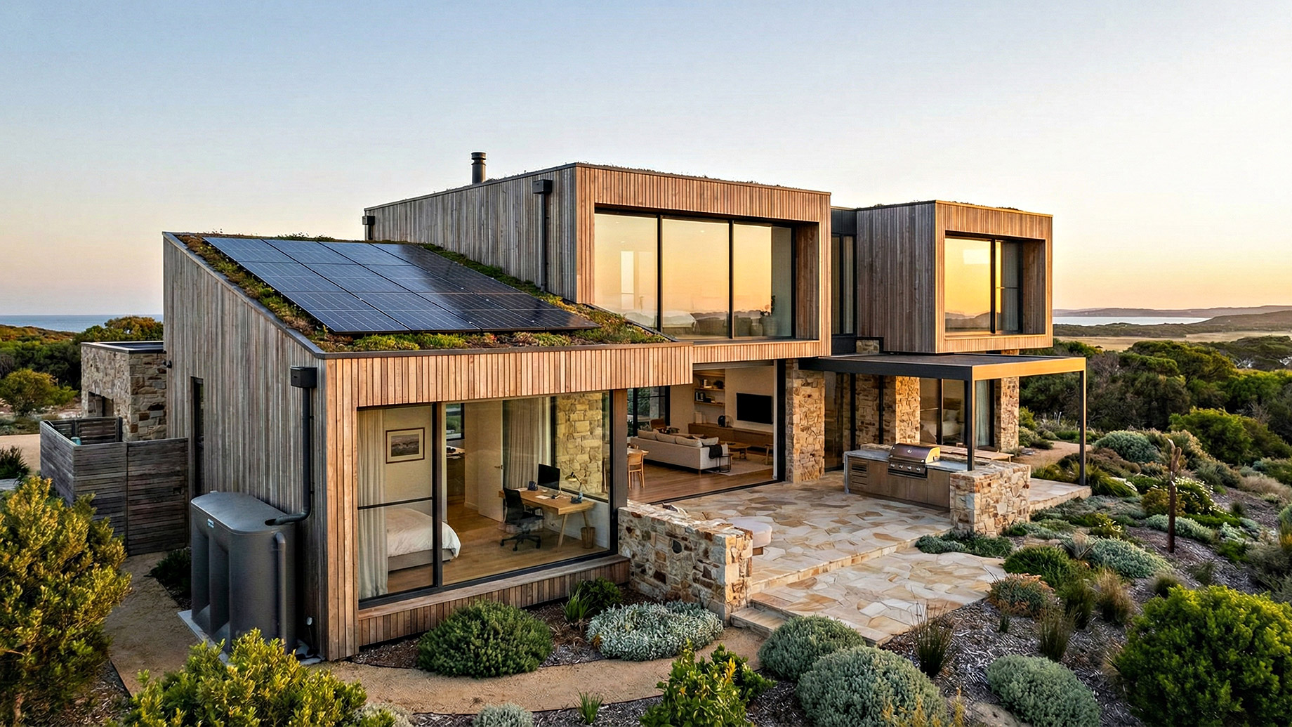 A contemporary eco-friendly luxury home showcasing 2026 construction trends, featuring rooftop solar panels, modular timber and stone architecture, and expansive floor-to-ceiling glass walls that seamlessly blend indoor and outdoor living spaces at sunset.