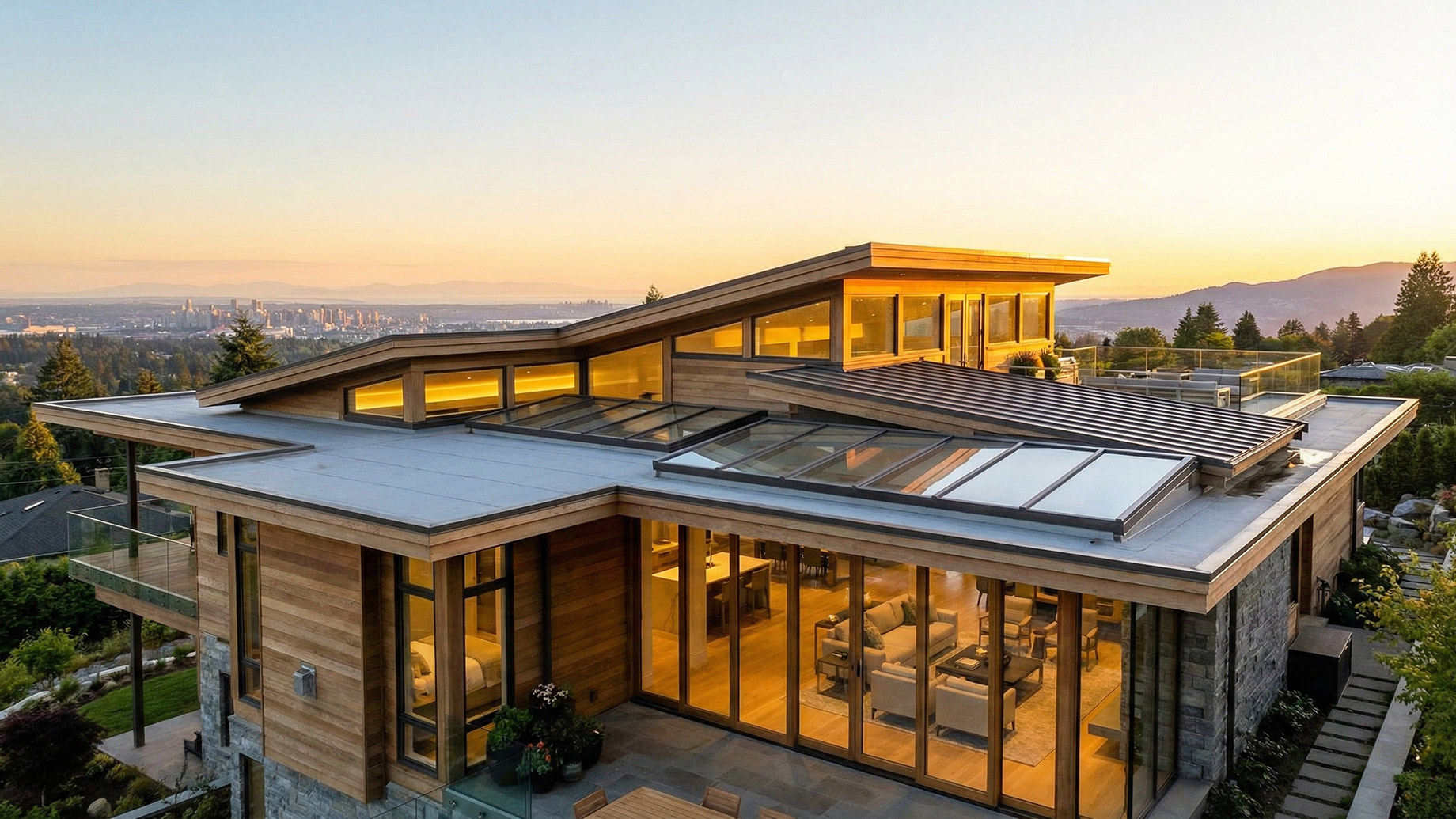 A luxury modern home at sunset with extensive skylights, clerestory windows, and a rooftop terrace, demonstrating how roof design can maximize natural light and offer panoramic city views.