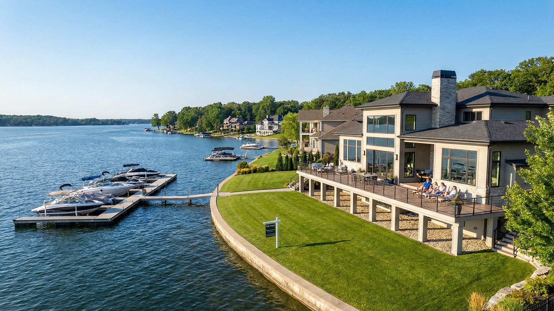 A sprawling luxury waterfront estate featuring a private boat dock and spacious deck overlooking the lake, representing the vibrant real estate market and lifestyle at the Lake of the Ozarks.