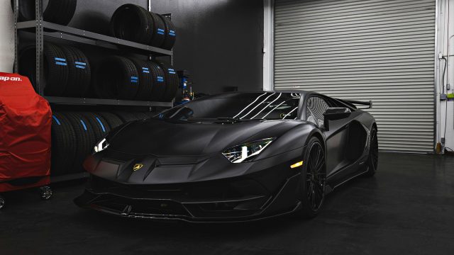 Matte Black Lamborghini Aventador in a Garage