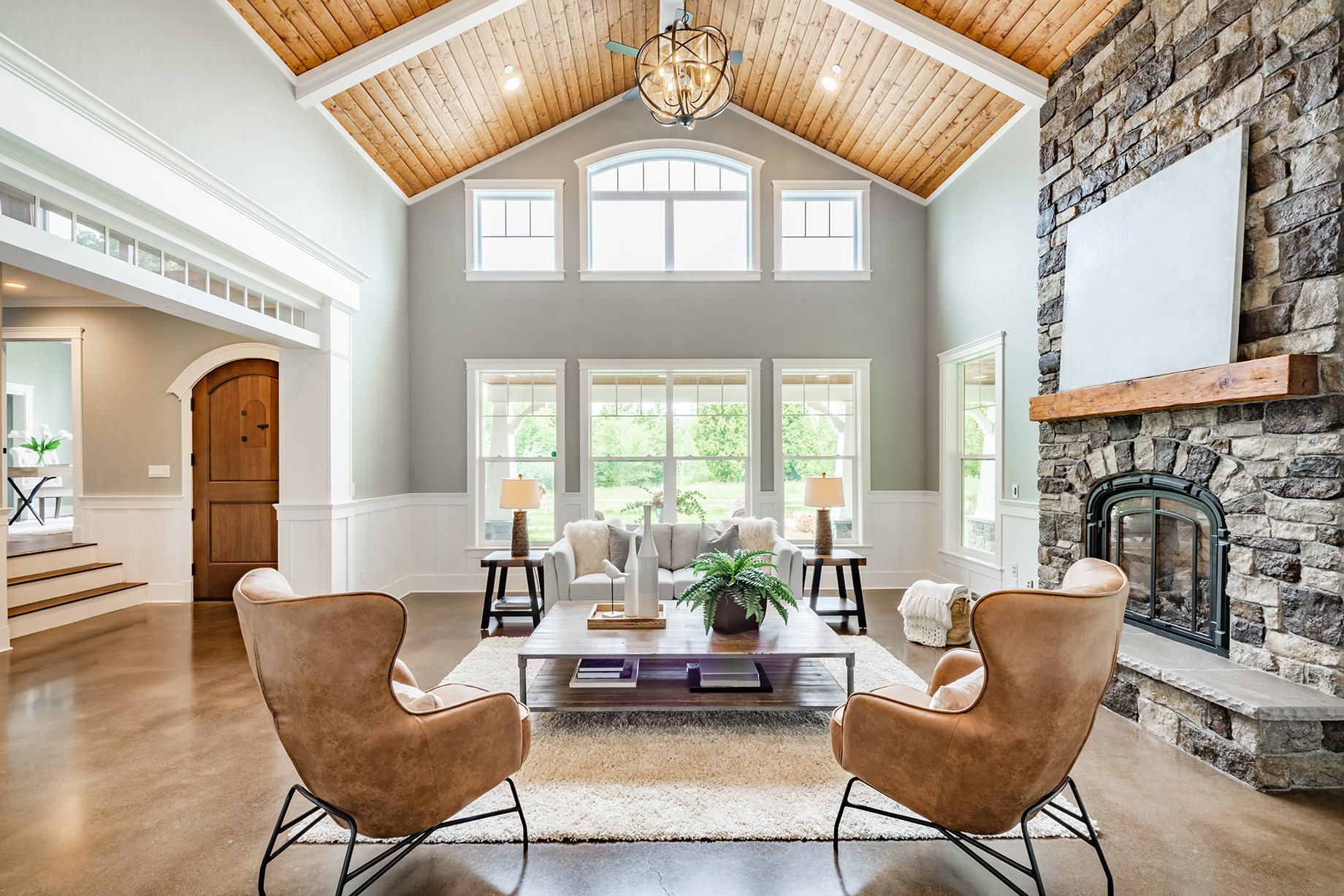 Living Room Interior with Vaulted Ceiling and a Wood Cedar Panelling Stone Fireplace