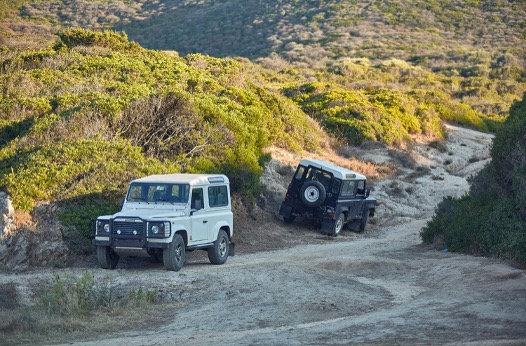 Two SUVs Driving on a Rugged Off-Road Trail Two SUVs Driving on a Rugged Off-Road Trail