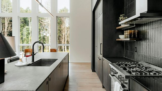 A Modern Contemporary Kitchen With a Stove Top Oven Next to a Window