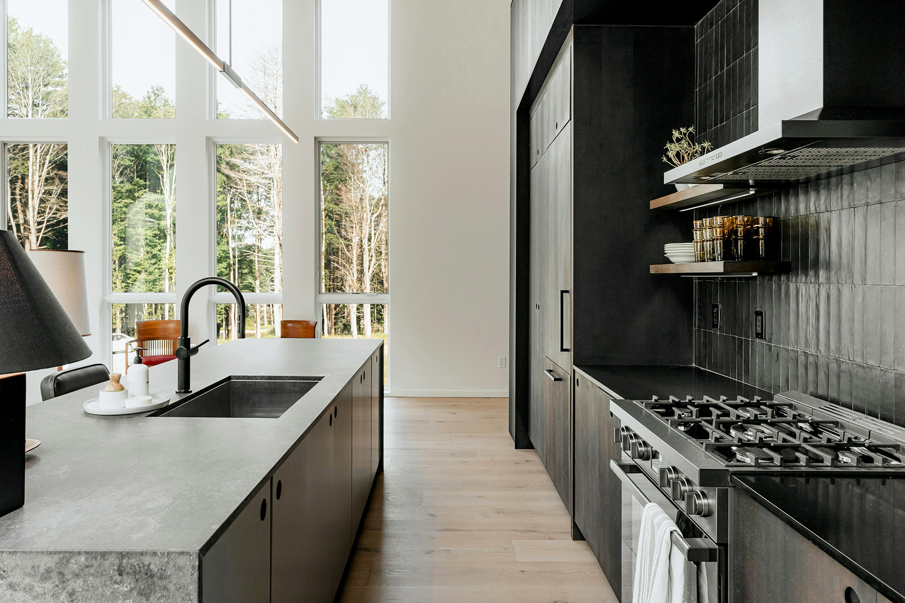 A Modern Contemporary Kitchen With a Stove Top Oven Next to a Window