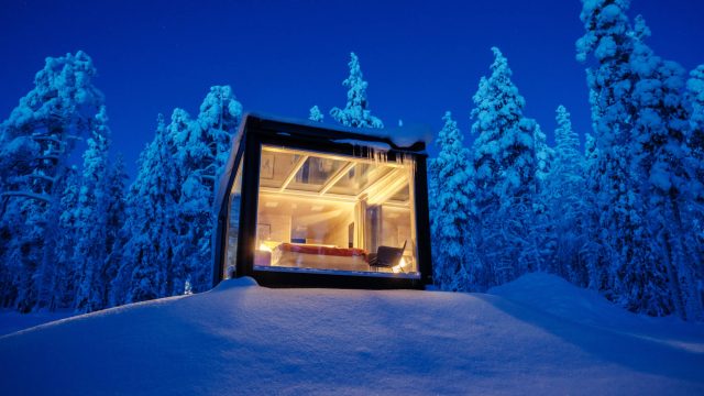 Glass Cabin in the Snow-covered Wilderness of Akaslompolo, Lapland, Finland