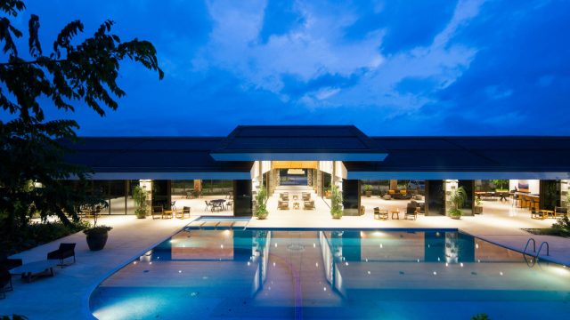 Luxury Modern Waterfront Mansion With Pool at Dusk