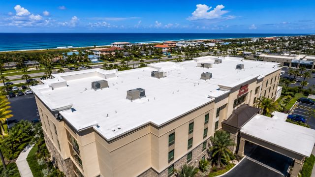 Large commercial flat roof overlooking the Atlantic coastline and surrounding properties near Myrtle Beach, South Carolina.
