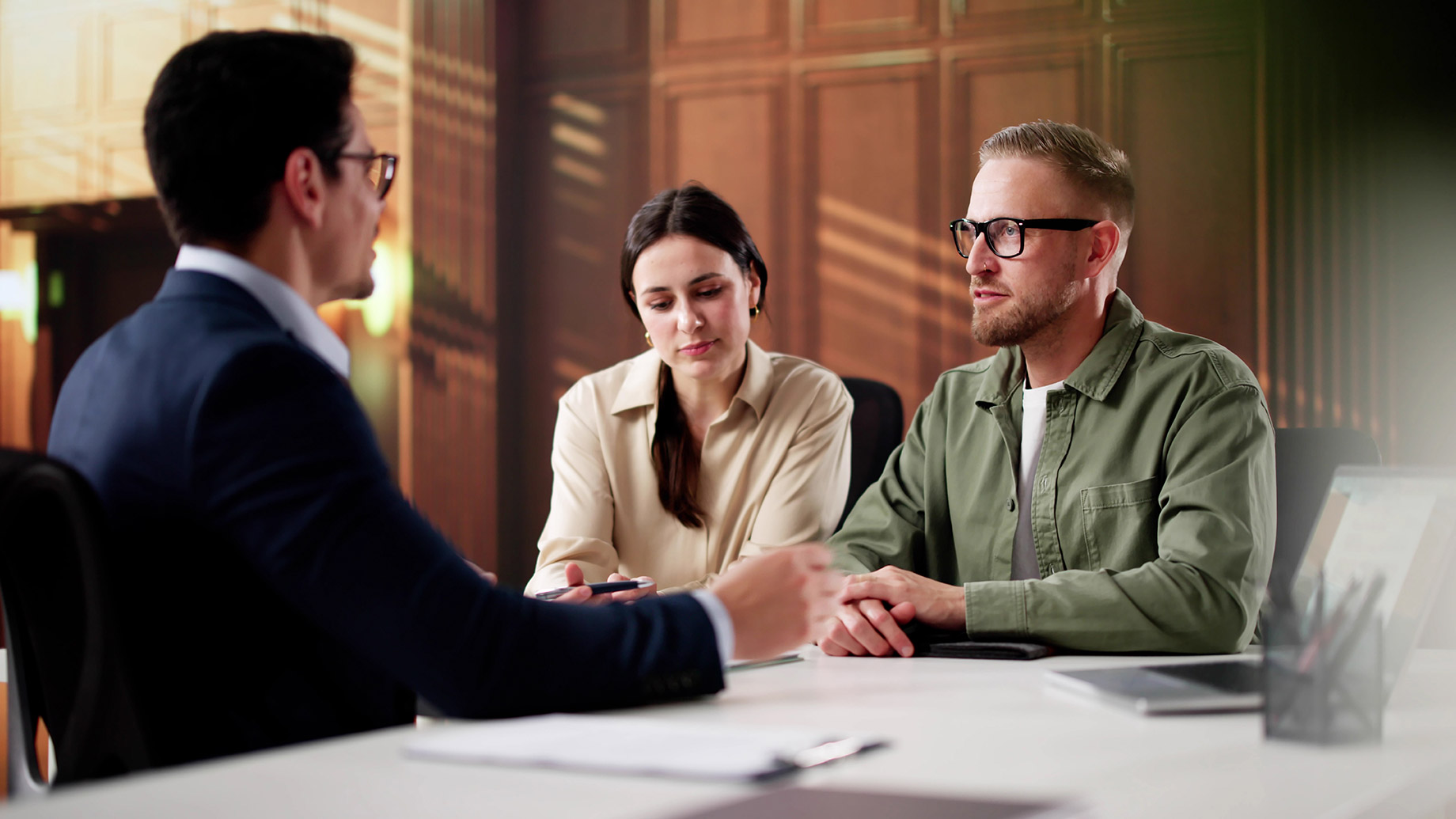 Couple seated across from an attorney during a divorce consultation in a modern law office.