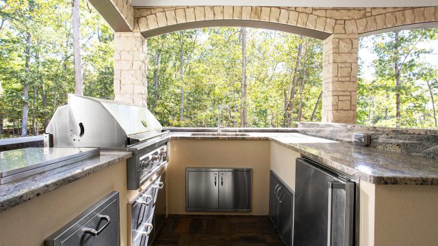 Modern Outdoor Kitchen with Stainless Steel Appliances and Granite Counters