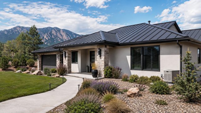 Modern Boulder home with a metal roof, protected windows, backup generator, fire-conscious landscaping, and Flatirons mountain views.