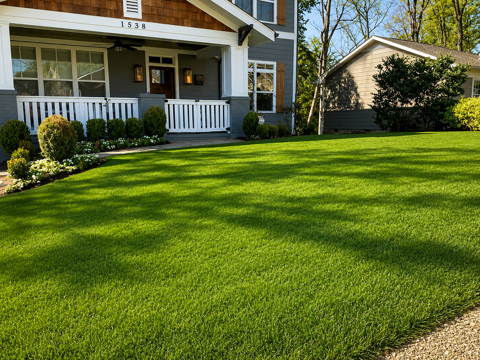 Lush green residential lawn outside a well-maintained suburban home.