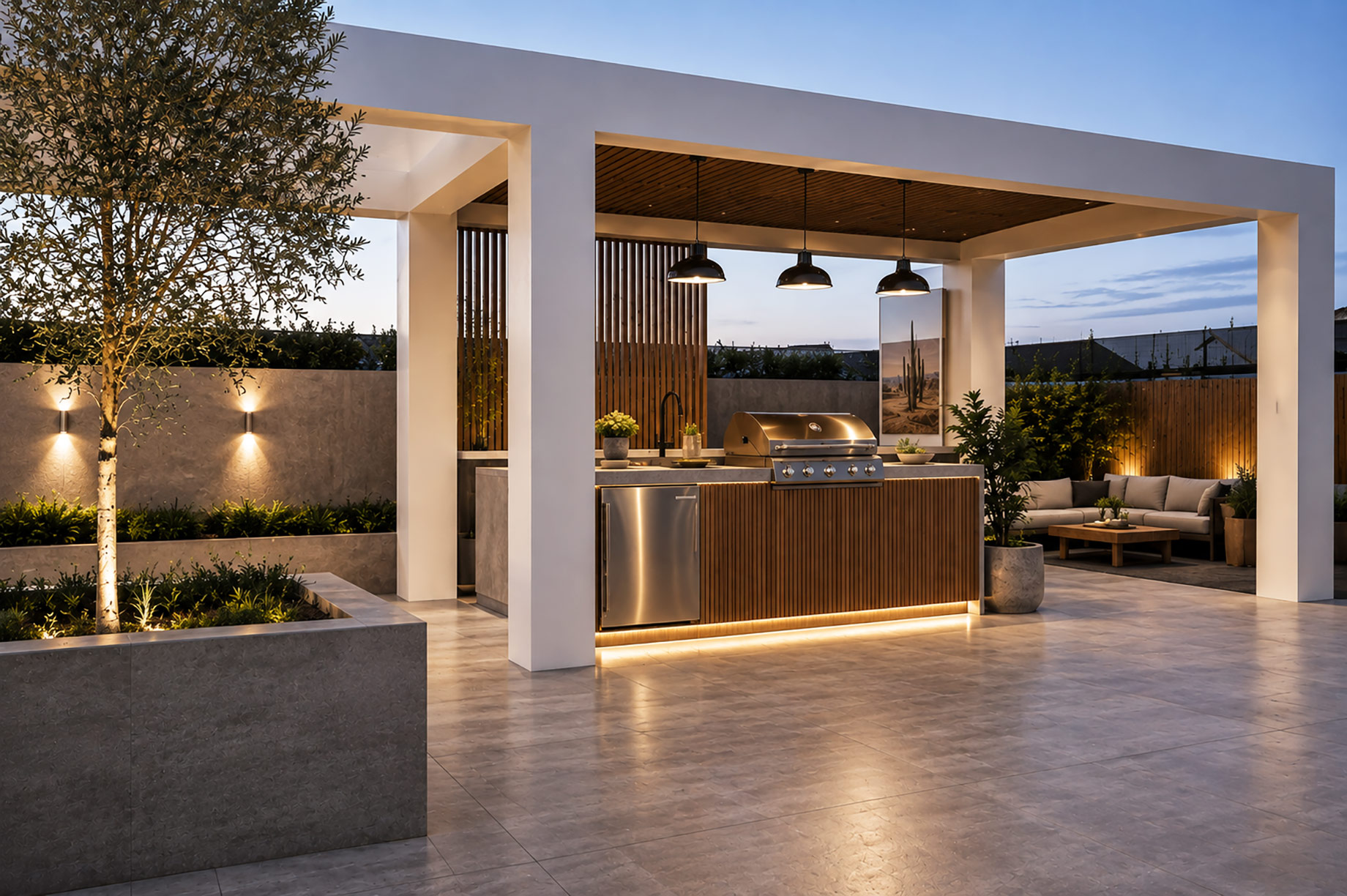 Contemporary Australian outdoor entertaining area with built-in barbecue, outdoor fridge, covered kitchen, lounge seating, and landscaped surroundings.