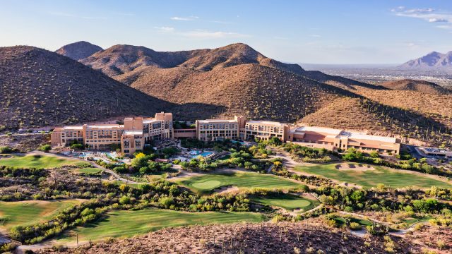Aerial view of a luxury resort and golf course surrounded by the Sonoran Desert and rugged mountains in Tucson, Arizona.