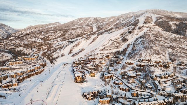 Aerial view of Steamboat Springs, Colorado, showing ski slopes on Mt. Werner surrounded by snow-covered homes, condominiums, and resort developments.