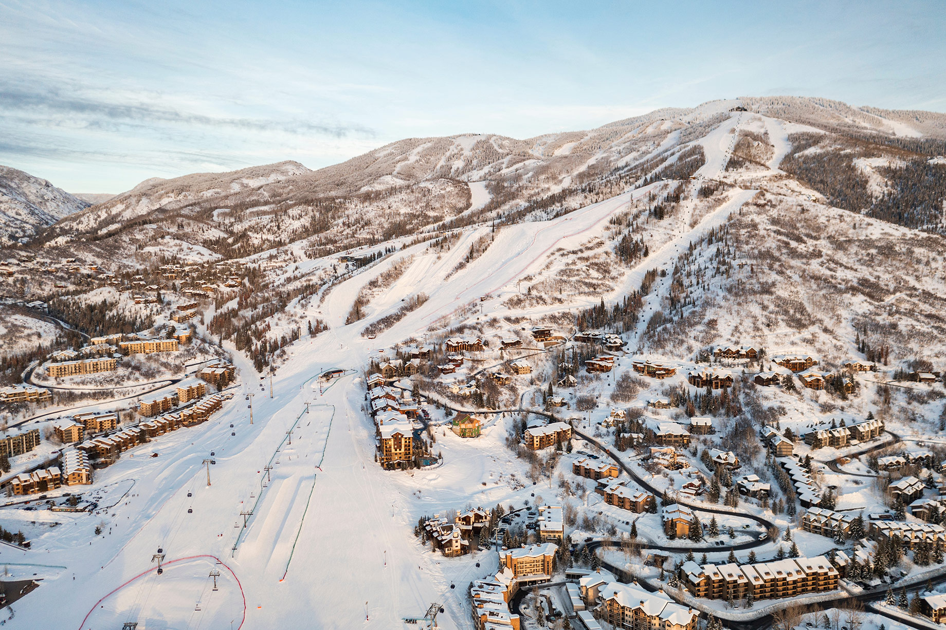 Aerial view of Steamboat Springs, Colorado, showing ski slopes on Mt. Werner surrounded by snow-covered homes, condominiums, and resort developments.