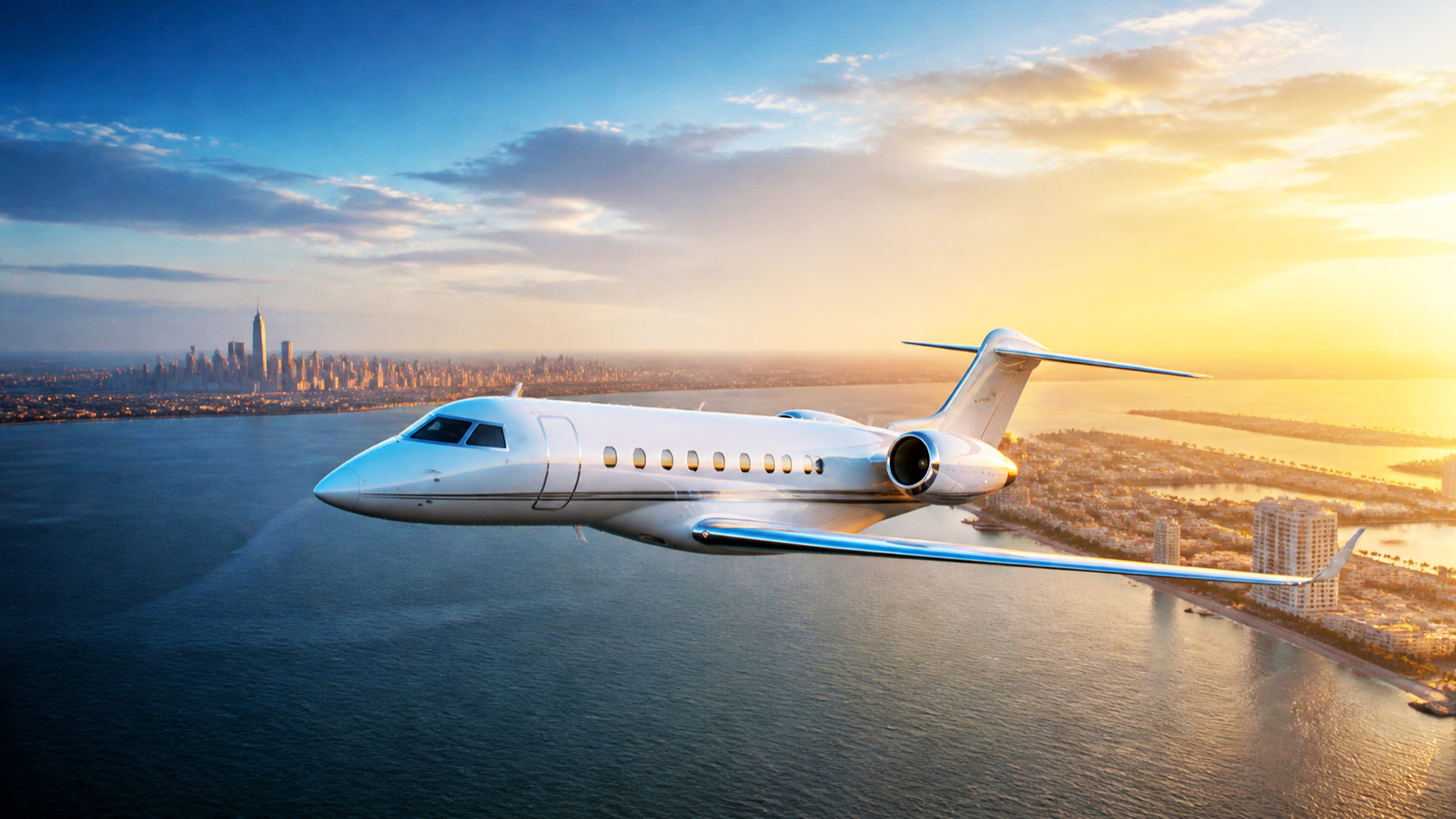 White private jet flying between the Manhattan skyline and South Florida’s sunlit Atlantic coast.